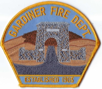 Gardiner Fire Department (MT)
The "big arch" made in honor of President Theodore Roosevelt is the Roosevelt Arch at the north entrance of Yellowstone National Park. President Roosevelt laid the cornerstone in 1903 and dedicated the 50-foot tall stone gateway made of basalt.  Population <2,000.
